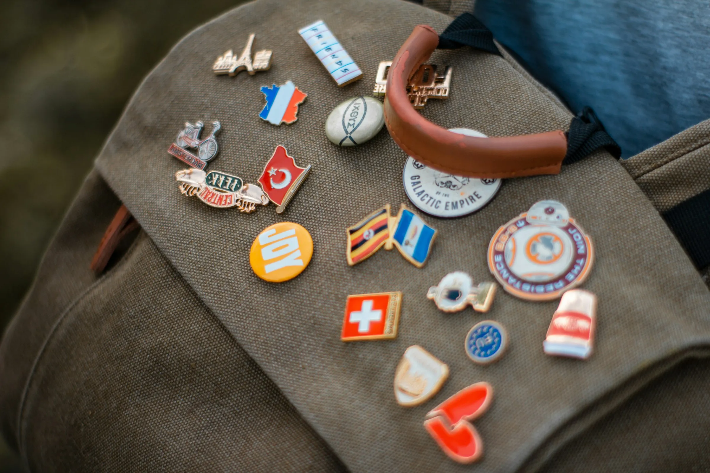 A backpack covered in an assortment of badges, each representing unique interests and experiences.